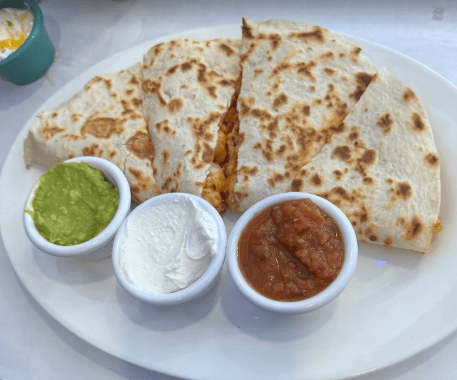 Seafood taco platter served with fresh lime and toppings
